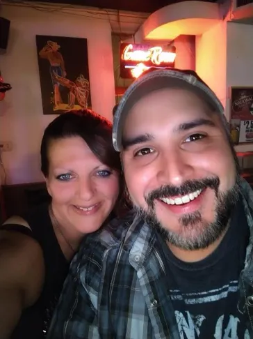 Mark and a fan selfie at a country bar with neon signs