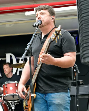 Vocalist and bassist performing on stage