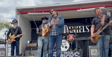 Band performing outdoors at festival