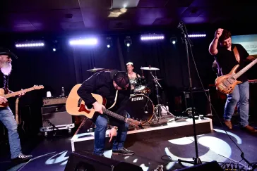 Full band performing on stage