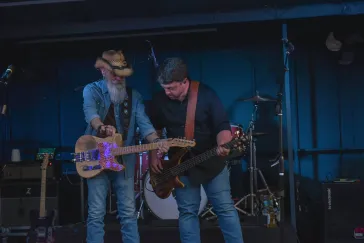Dino and guitarist playing together on stage