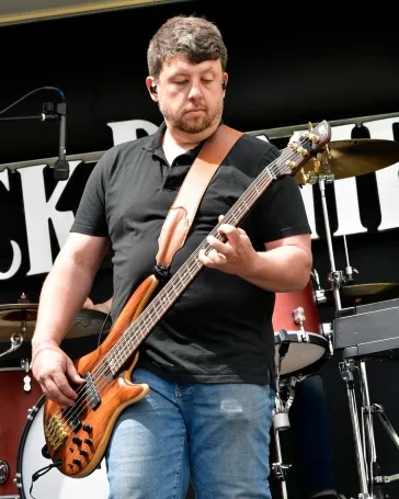 Tom on bass performing live