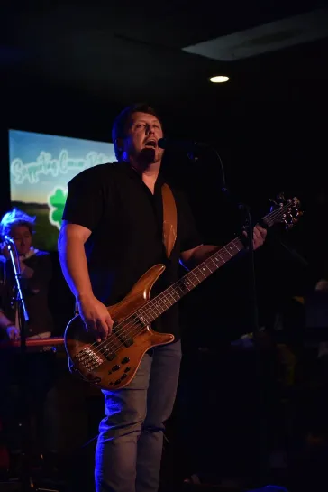Tom on bass performing live