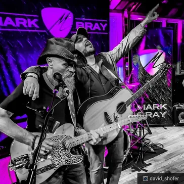 Black and white performance photo with magenta lighting