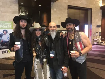 Group of fans with the band at an event