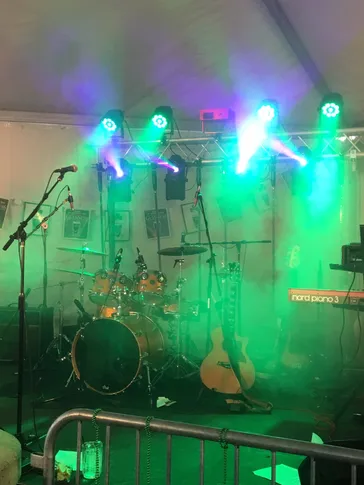 Stage setup with green lighting and fog