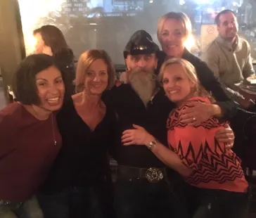 Mark surrounded by fans at a show