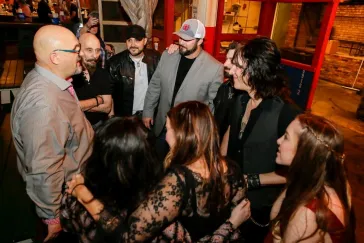 Group of people chatting at an indoor venue