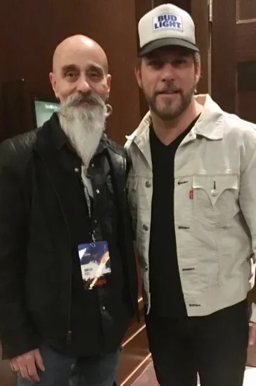 Mark posing with a fan at a show