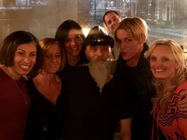 Dino surrounded by fans at an after-show gathering