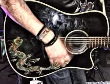 Close-up of acoustic guitar with dragon artwork